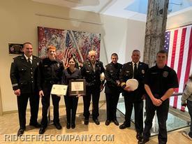 FF Carmen Shields with Members of the Ridge Fire Co in front of the WTC Steel Memorial at the PTSC. 